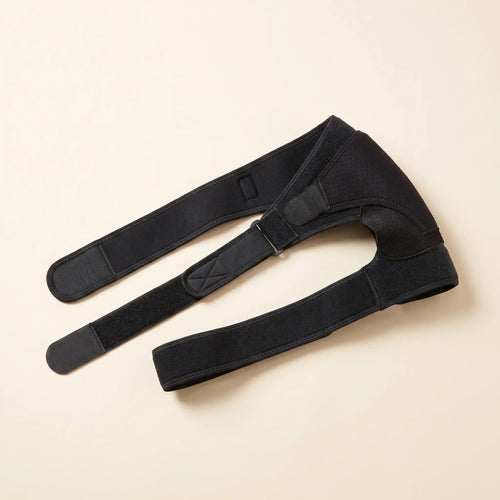 Épaulière de compression Flexnea en néoprène noir à sangles ajustables, sur fond crème