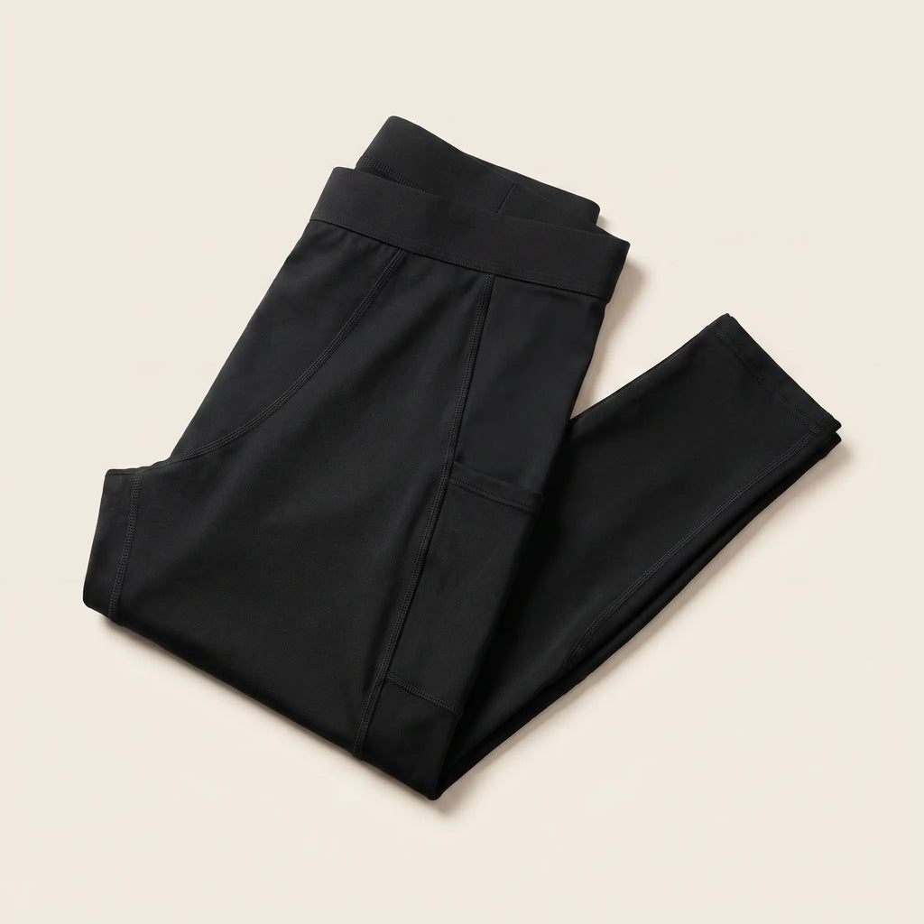 Collant de compression Flexnea noir plié, ceinture large visible, sur fond crème
