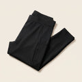 Collant de compression Flexnea noir plié, ceinture large visible, sur fond crème
