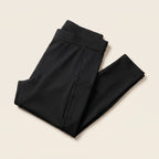 Collant de compression Flexnea noir plié, ceinture large visible, sur fond crème
