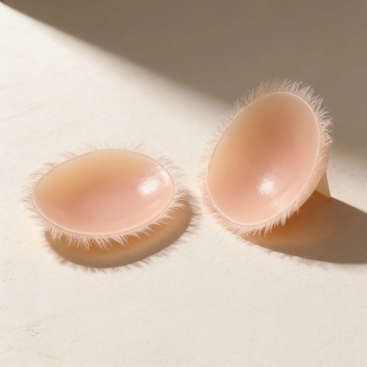 A pair of ultra-thin Invisible Inserts with feathered edges