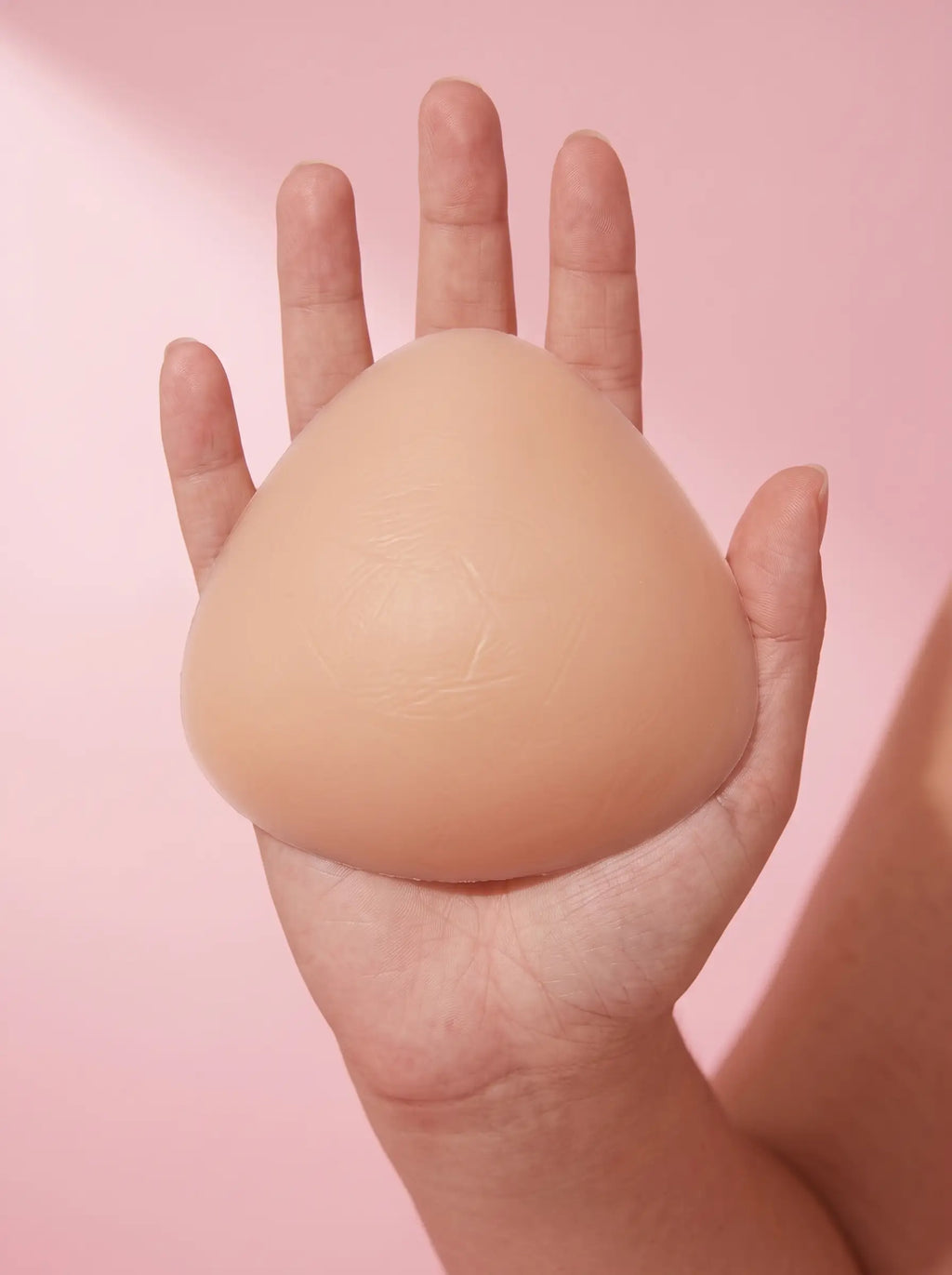 A Sculpt Insert resting across an open palm, showing its true size